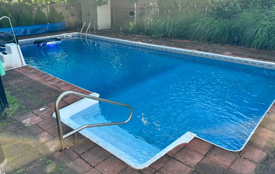 Clean clear blue pool water after professional algae treatment